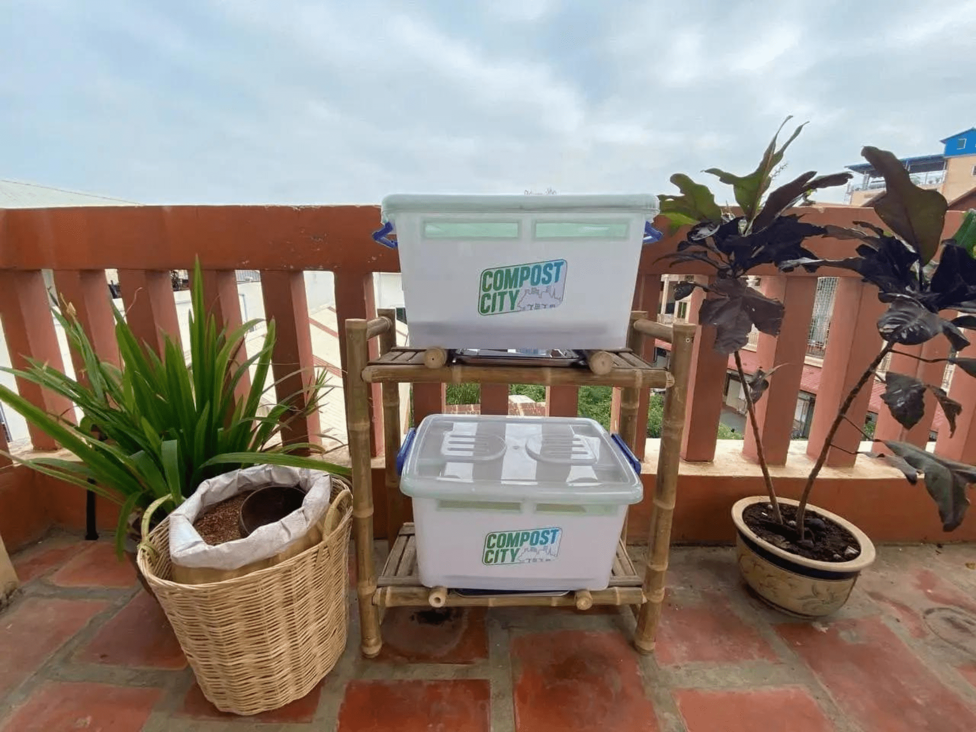 Two plastic bins with the logo of Compost City used to collect customers' food scraps across Phnom Penh.