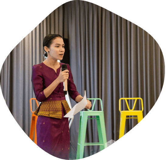A female in khmer traditional outfit presenting her idea about Urban Mobility Incubator in Cambodia.