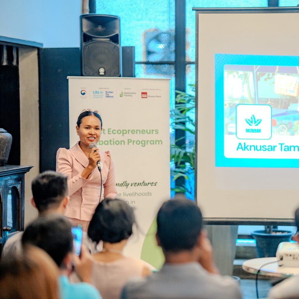 A woman pitching her business on stage during the Forest Ecopreneurs 2025 Closing Event